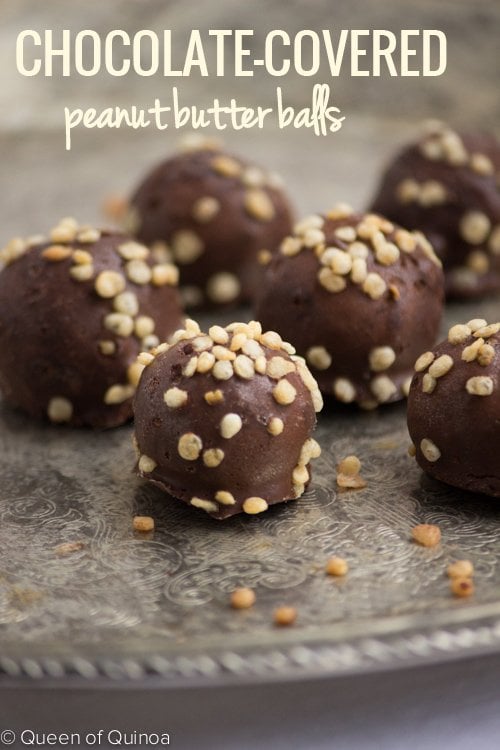 Nuts cover these Chocolate Covered Peanut Butter Balls. They rest on a silver tray. 